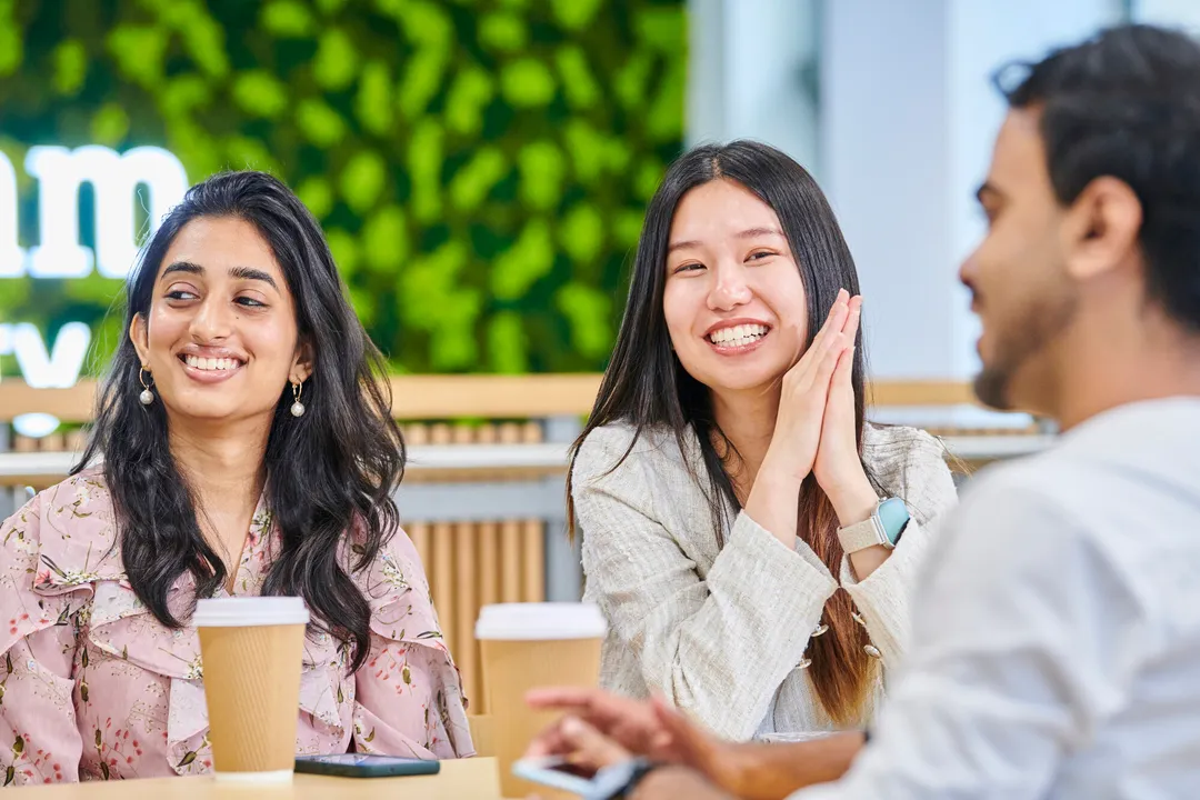 Group of smiling students at the Business School's Waterside building