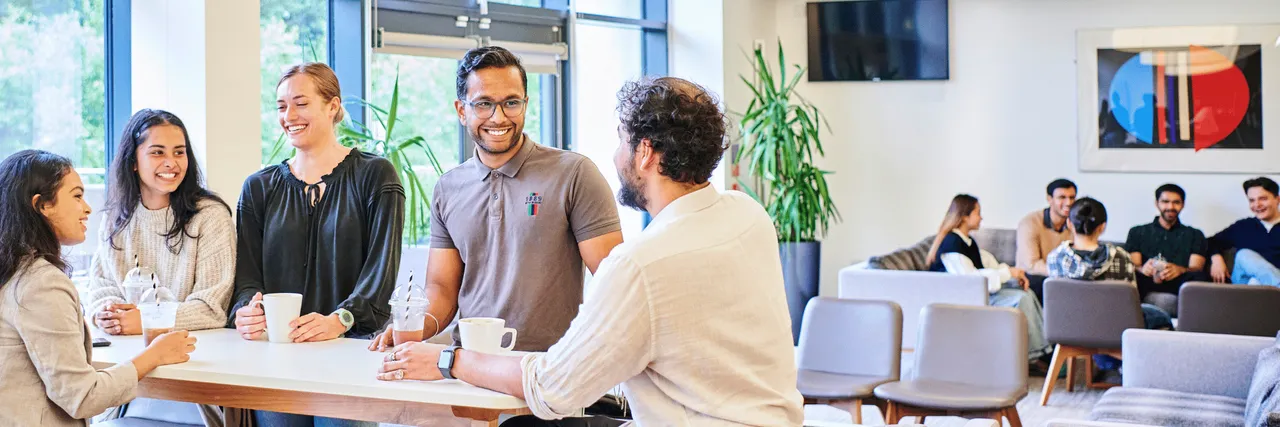 A group of students chatting and drinking coffee