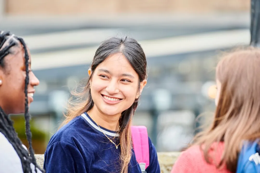 Three female students, one facing the camera