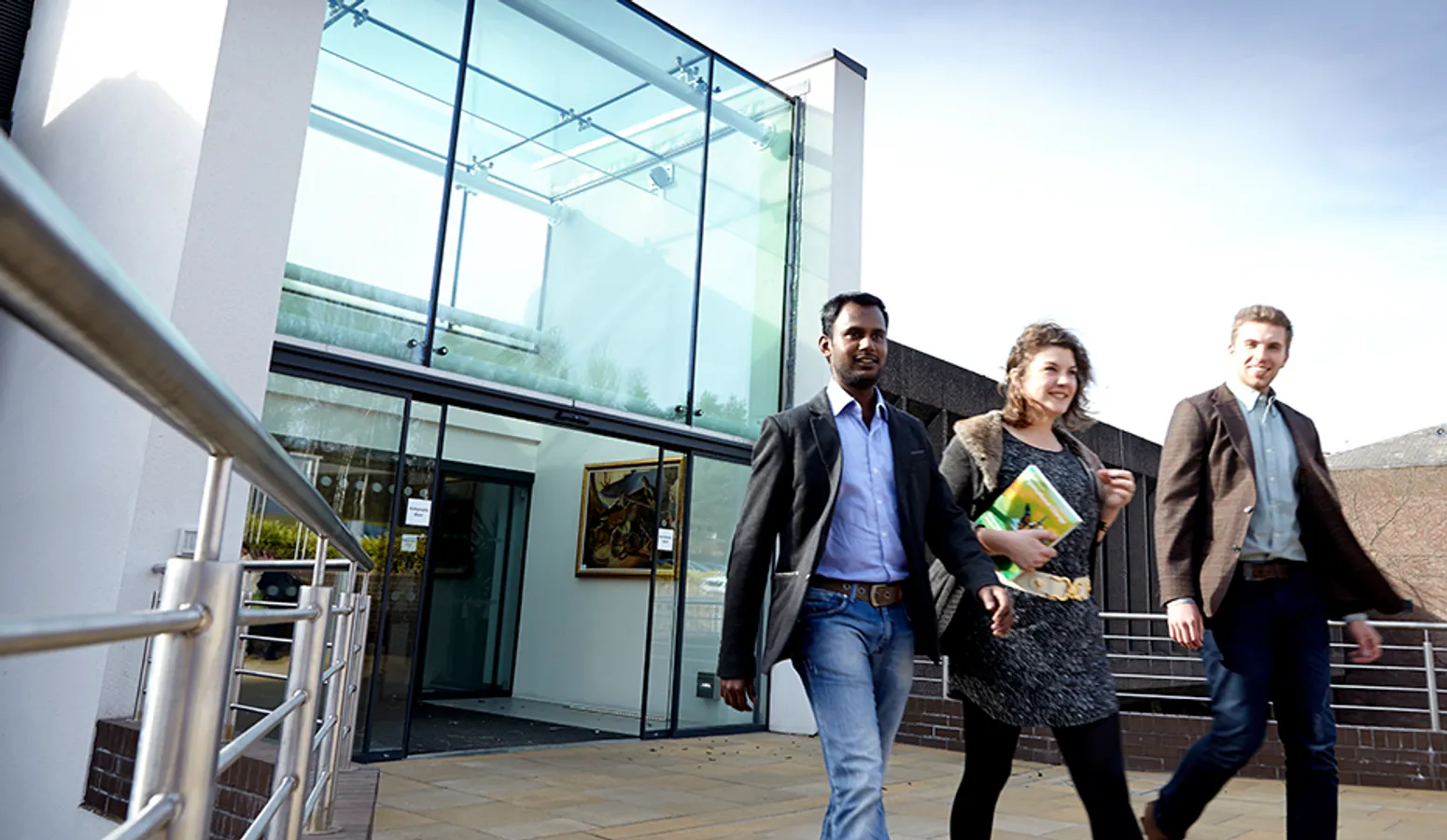 People exiting the Business School via the main entrance