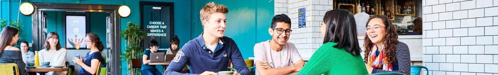 A group of students chatting in a college bar