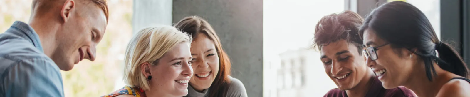 5 Students working and smiling