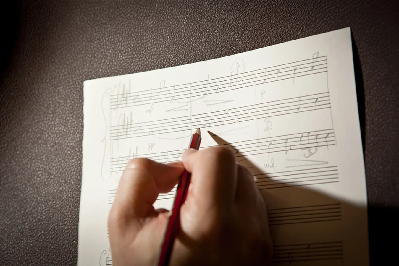 Someone writing sheet music