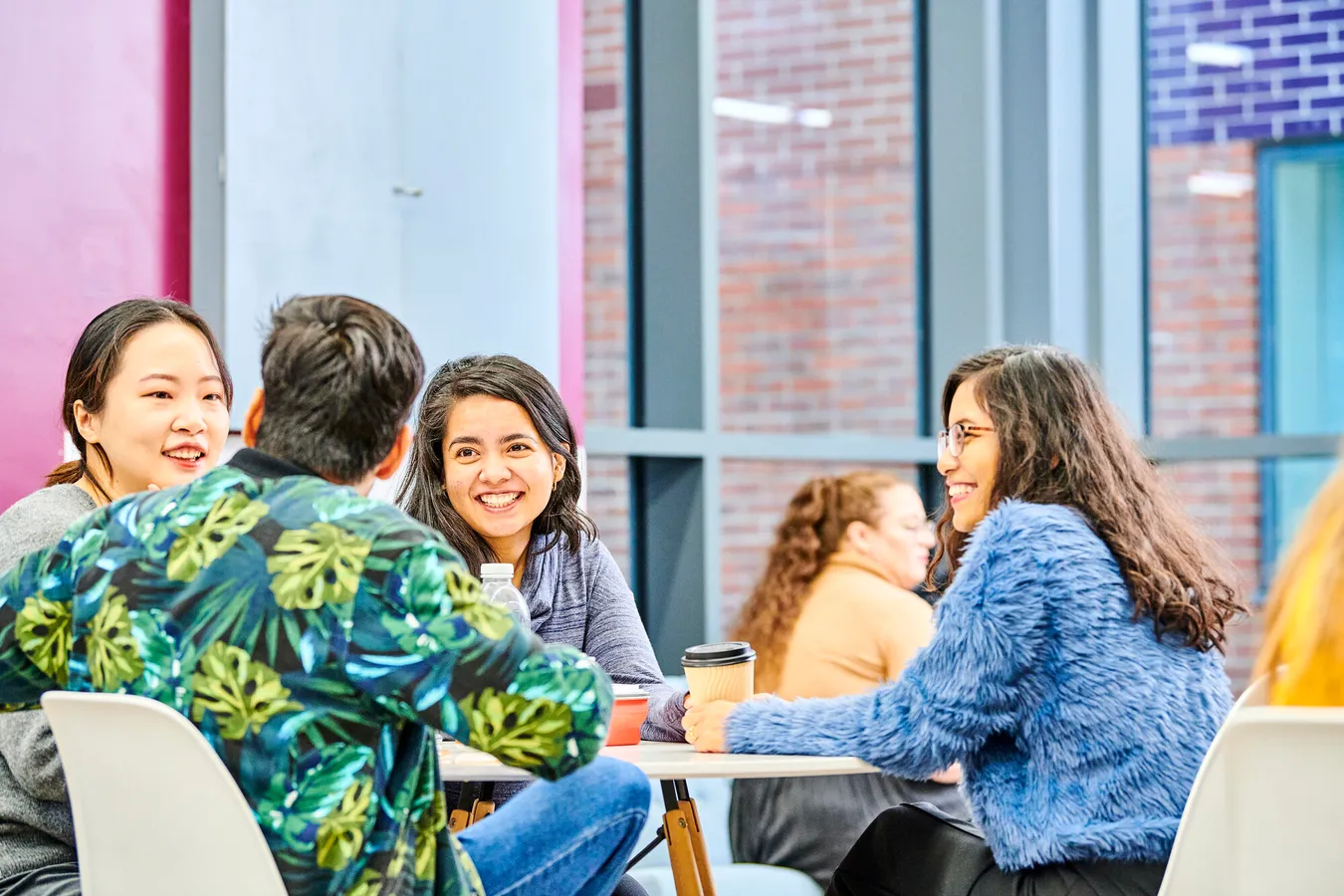 Group of postgraduate students sitting around a table