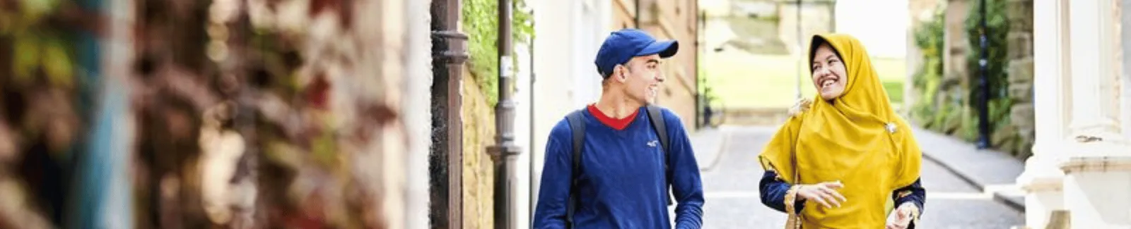 Two students walking in a Durham street chatting