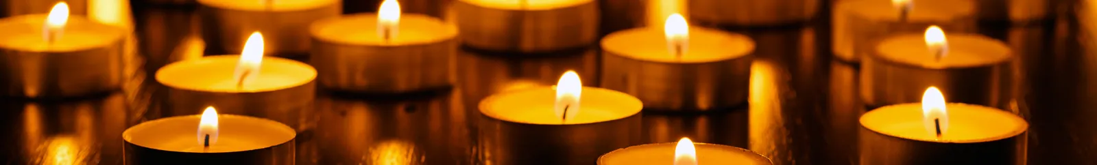 Burning tealight candles in a dark room