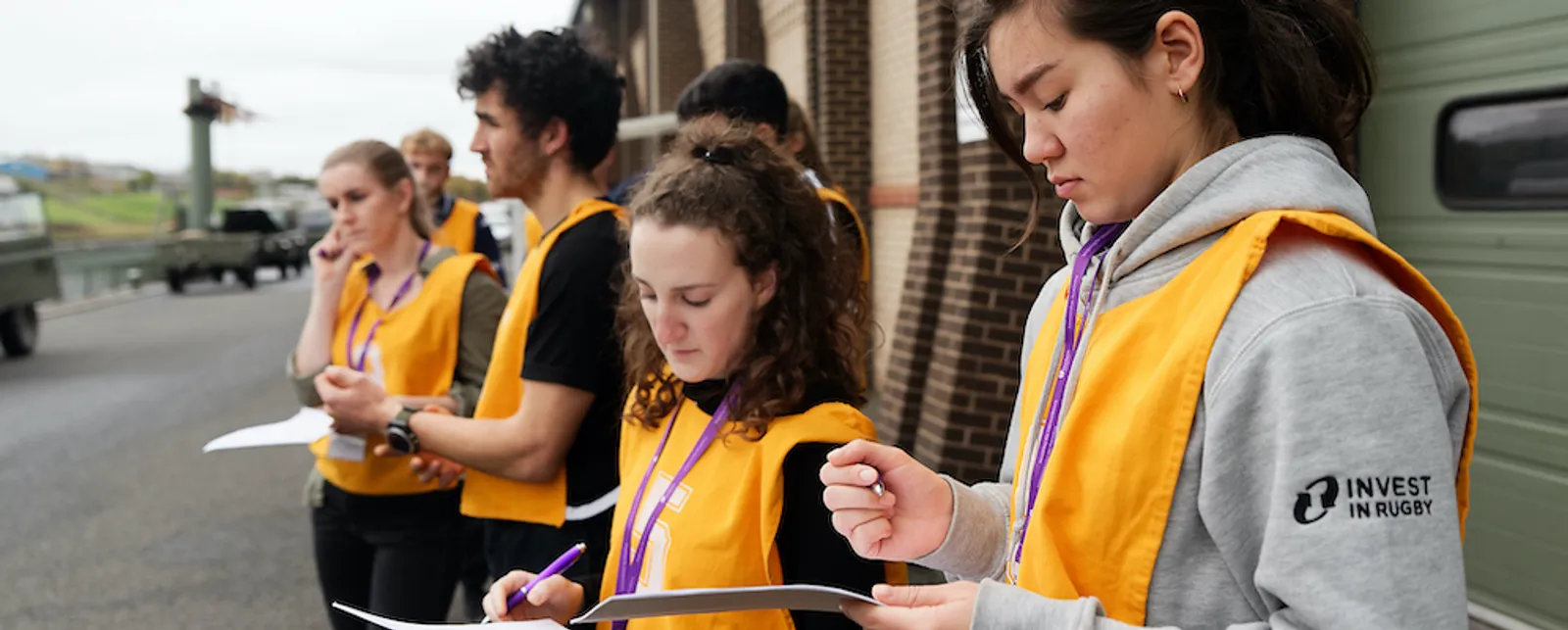 Students in high-vis work together outside