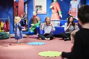 A member of Learning and Engagement Team working with a volunteer to run a Little Dragons under 5’s session in the Marvels of China gallery at the Oriental Museum, in front of terracotta warrior statues