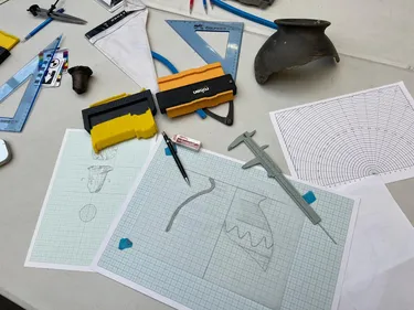 Photography of a table with an artefact being illustrated