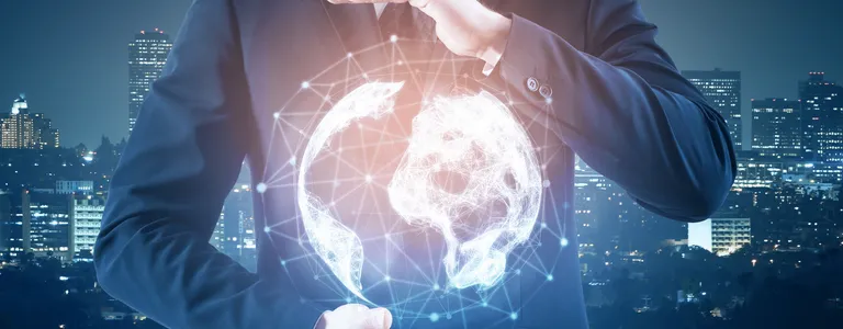 Man holding abstract glowing globe with a blurry city background