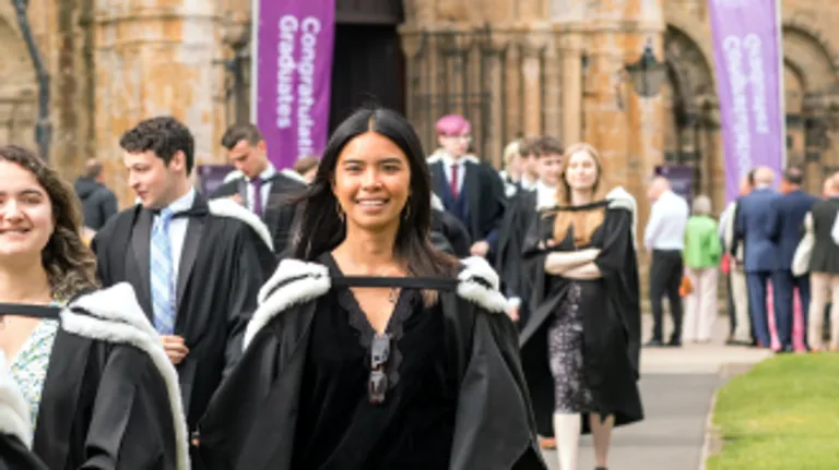 Student outside of Durham Cathedral after Congregation