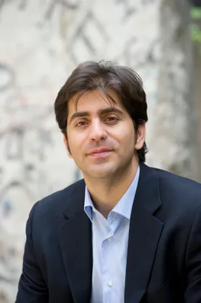 A headshot of Afshin Molavi with a blurred background