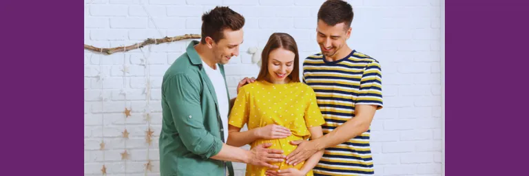 Two men stand beside a pregnant woman cradling her belly.