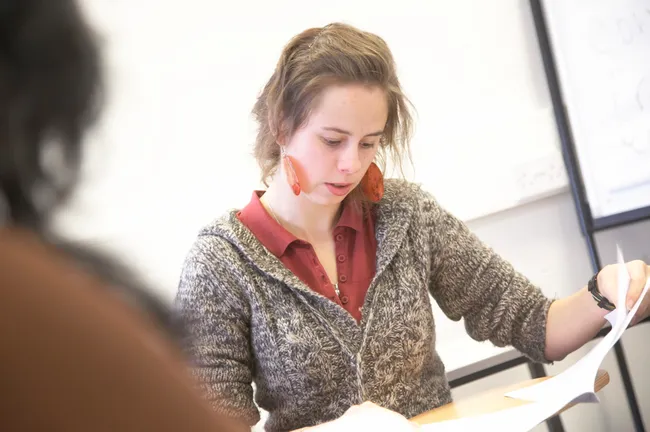 Student reading a booklet during a lecture