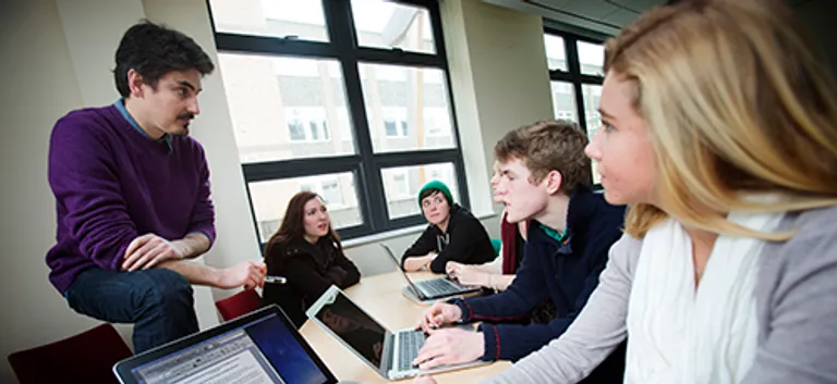 Group of students sat having a chat with their tutor