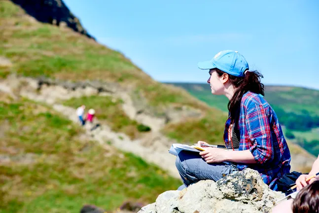 Woman sat on rocks