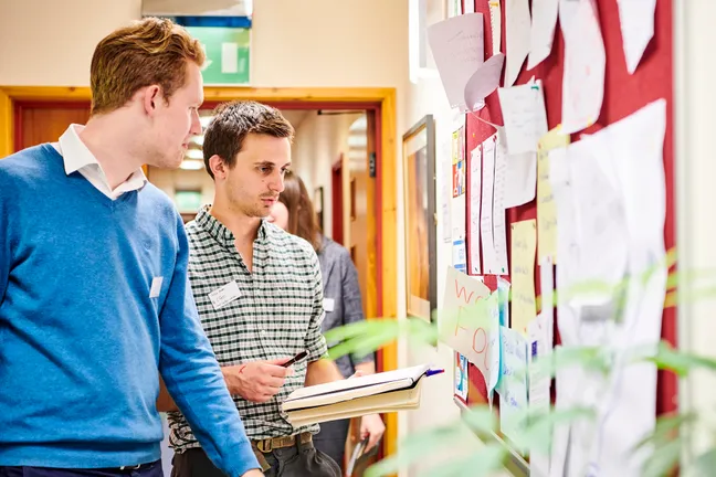 Students looking at a noticeboard