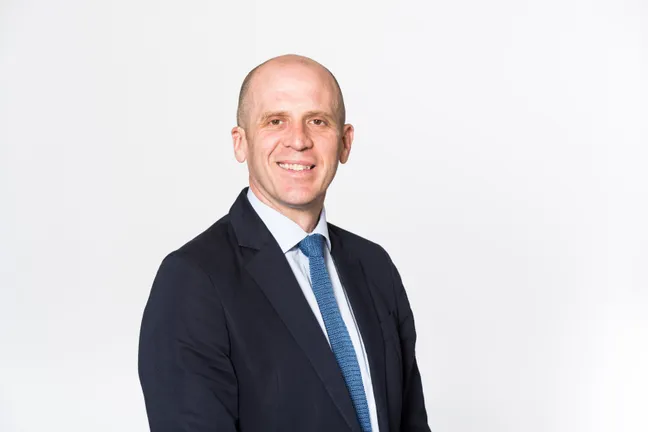 A man smiling with a white background