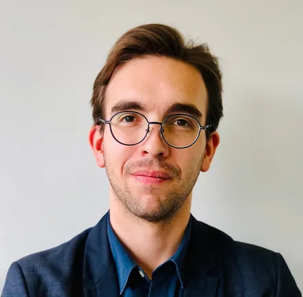 A portrait of a man with glasses