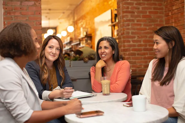 Group of people talking around a table
