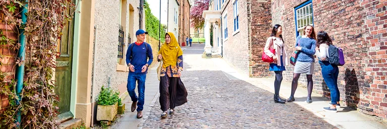 A busy Bow Lane, full of students on a sunny day