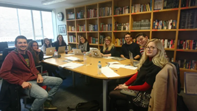 Class of 2018 smiling around a table