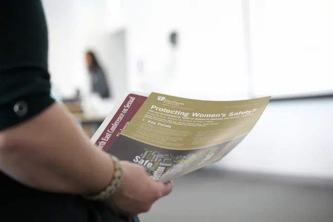 A person holding research briefing papers