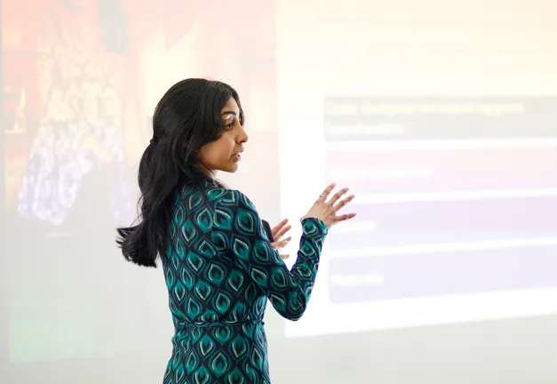 Research presenting in front of a large screen