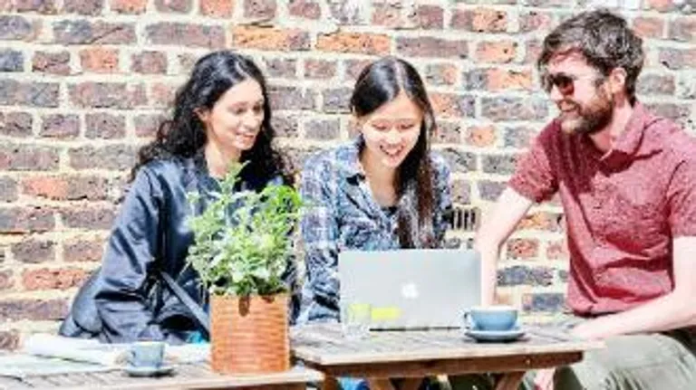 Students studying and drinking coffee outside