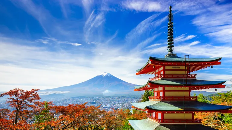Traditional Japanese architecture with Mount Fuji in the background