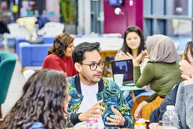 asian male student talking to others