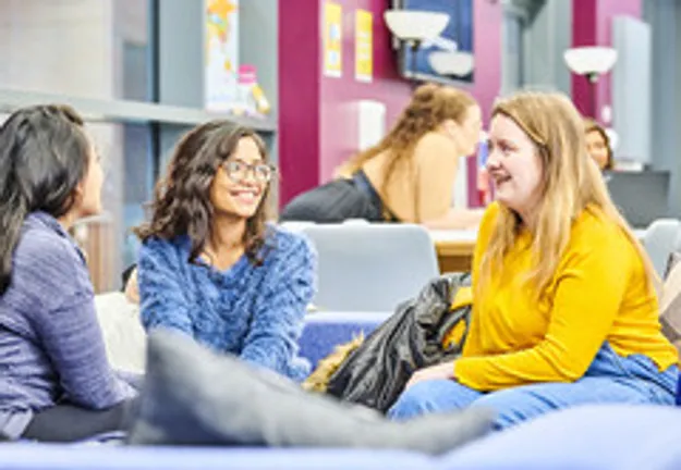 Two female students sat talking