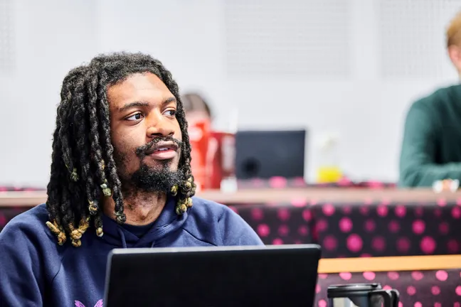 Postgraduate student in a lecture using a laptop