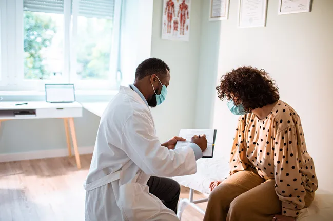 Doctor and patient in consultation wearing masks