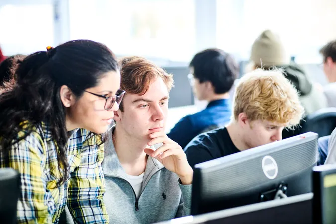 Academic and student at a computer