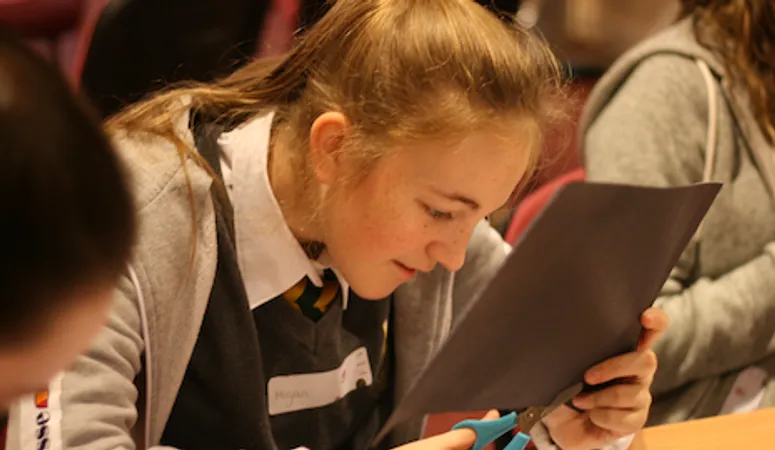 A school pupil chatting with a physics postgraduate
