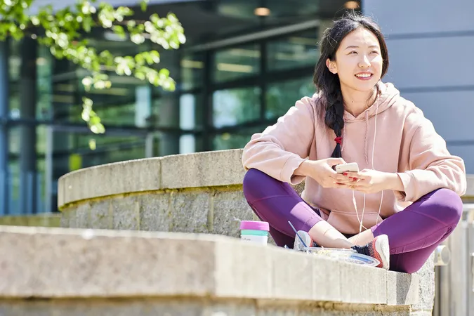 Student sitting on a wall