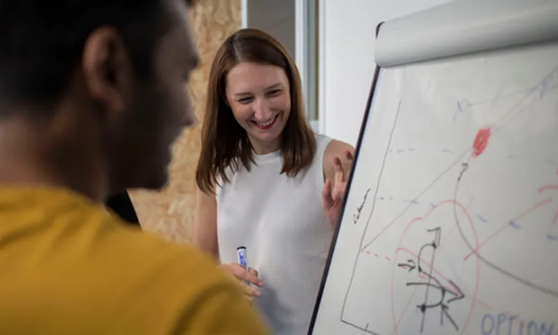 student talking through info on white board