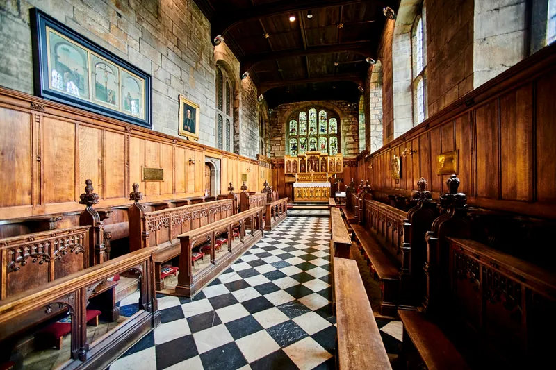 The Tunstall Chapel in Durham Castle. Looking east towards the stained-glass windows and altar.
