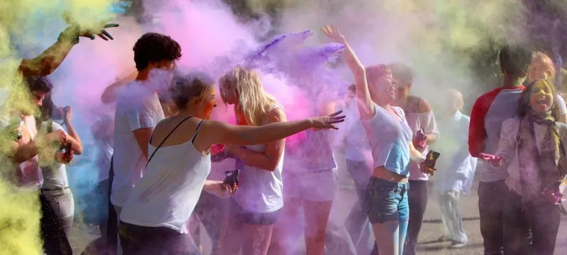 People throwing coloured powder at a Holi Festival