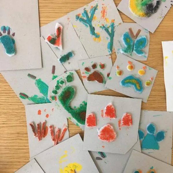 A collection of homemade prints covered in paint