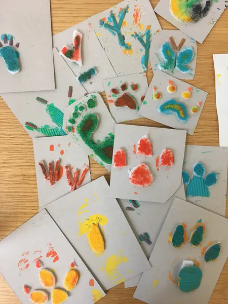 A collection of homemade prints covered in paint