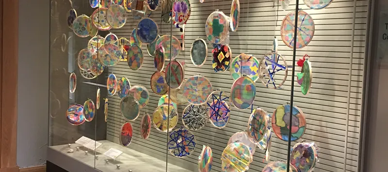 An art installation displayed behind glass