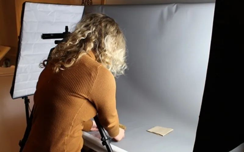 Photograph of a volunteer at the Museum of Archaeology working with the collection.