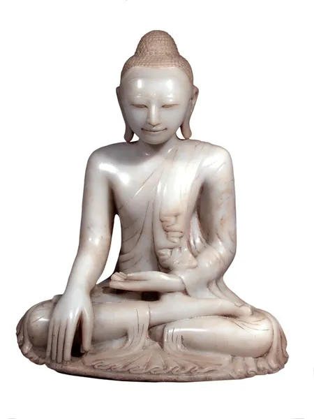 Image of white marble buddha, sat cross legged and meditating with one hand in his lap and the other touching the floor. His eyes are closed.