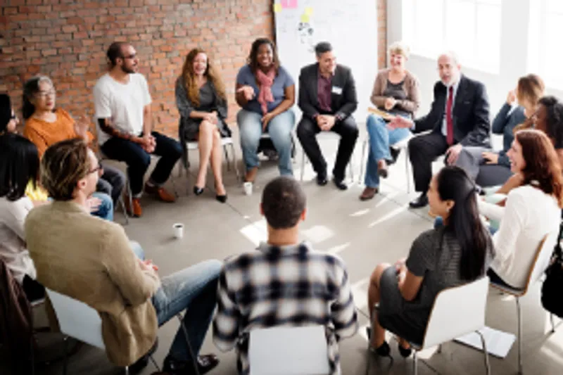 A business seminar with students seated in a circle