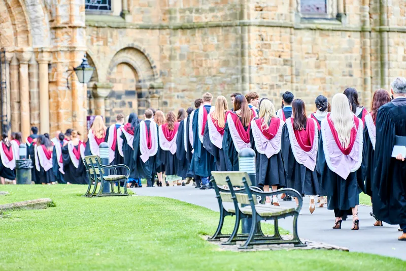 Students in academic gown processing into the cathedral
