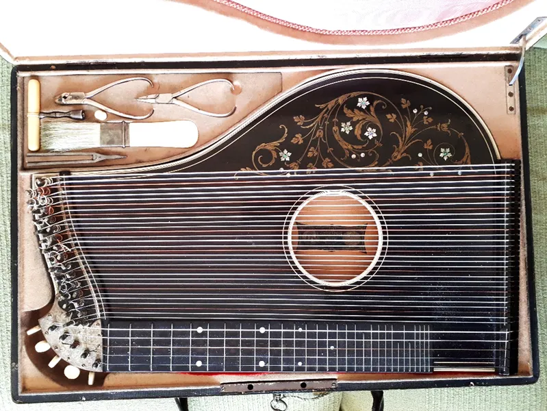 An ornate antique zither