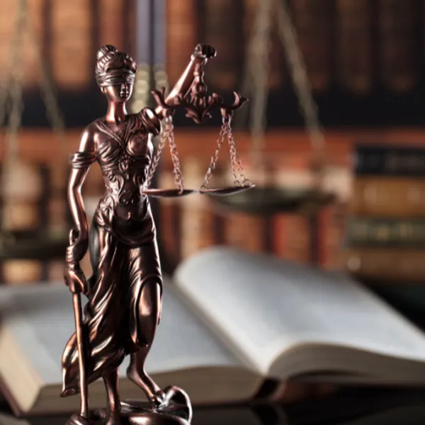 Scales of justice with books in the background