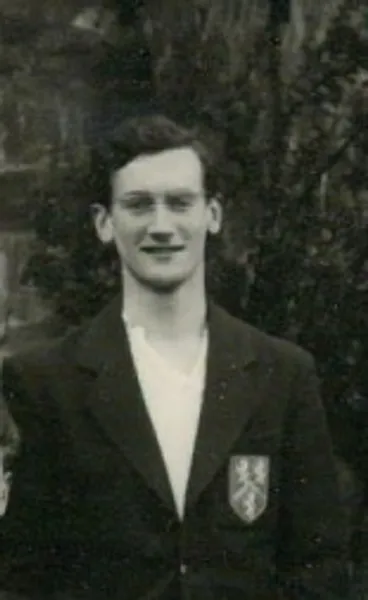 A black and white photo depicting Robin Stoddart as a student, wearing his college blazer